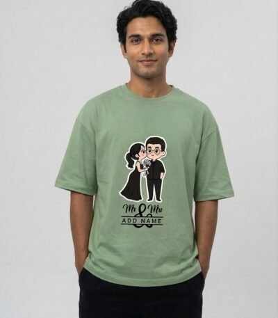 Model wearing a sage green Personalized Wedding Couple Unisex Terry Oversized Tee featuring a custom bride and groom graphic illustration.
