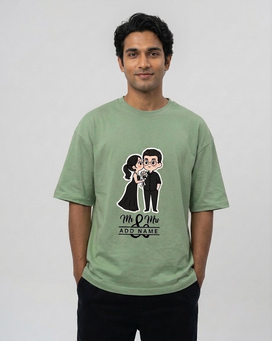 Model wearing a sage green Personalized Wedding Couple Unisex Terry Oversized Tee featuring a custom bride and groom graphic illustration.